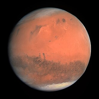 Mars, a reddish surface with white polar caps